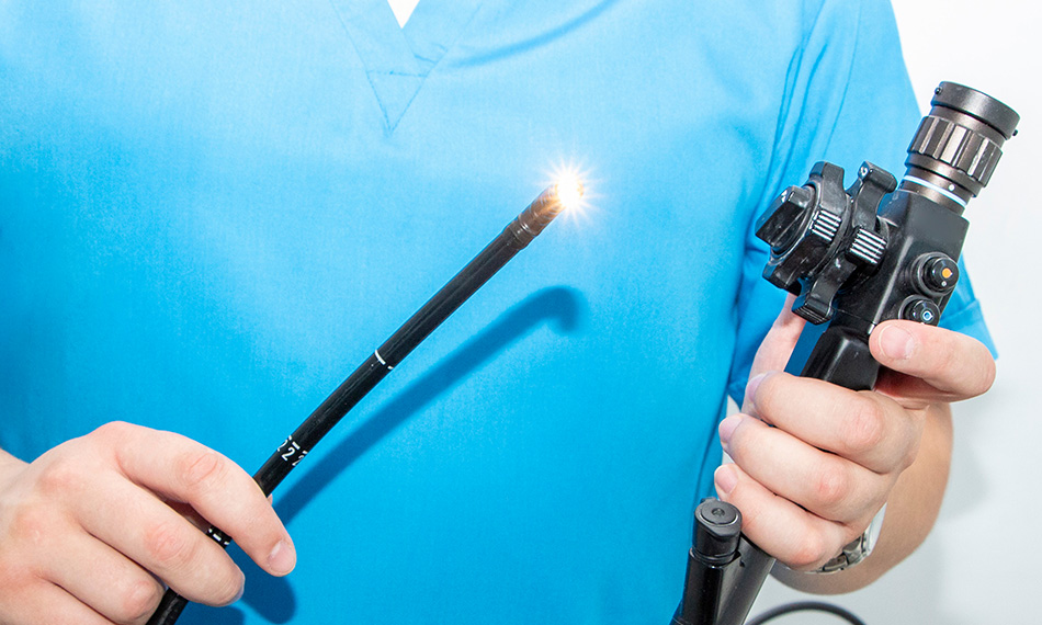 Endoscopy at the hospital. Doctor holding endoscope before gastroscopy. Instrument for endoscopy in the doctor's hands.